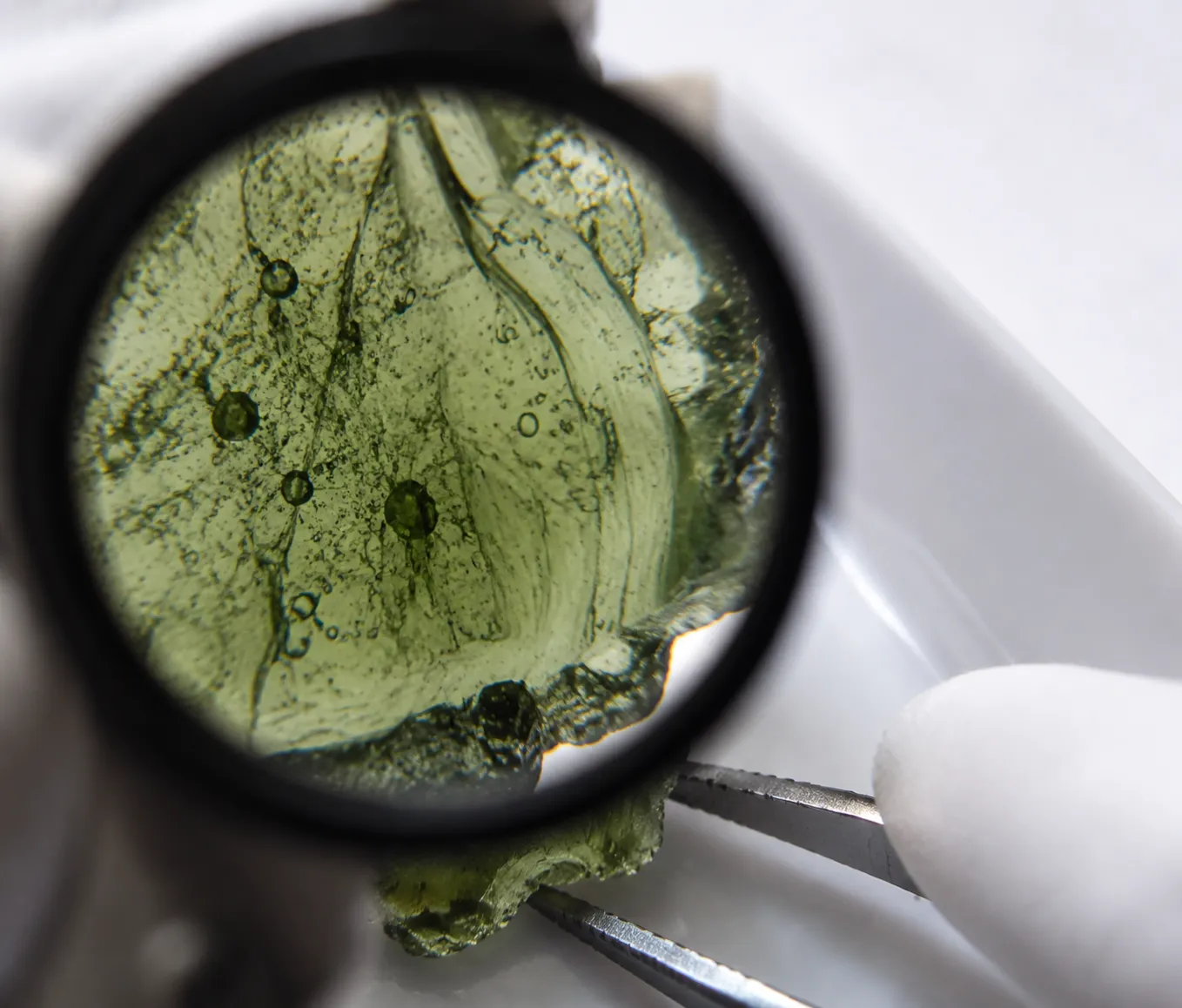 Close examination of moldavite showing why bubbles flow texture and internal activity must be interpreted together